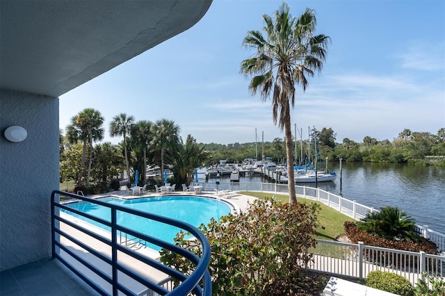 view of swimming pool with a water view