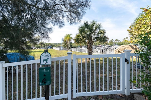 view of gate featuring a lawn