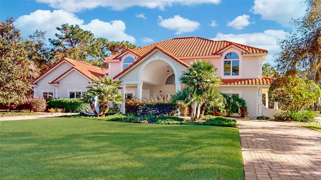 mediterranean / spanish home with a front yard