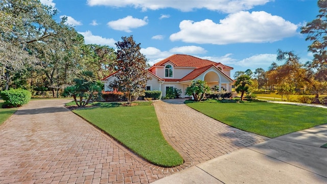 mediterranean / spanish home with a front lawn