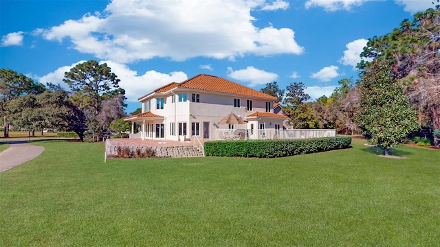 rear view of property with a yard and a patio area