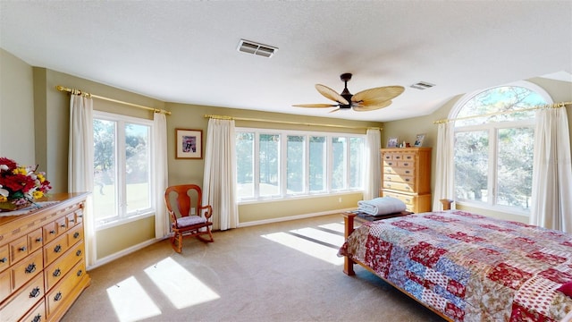 carpeted bedroom featuring a textured ceiling and ceiling fan