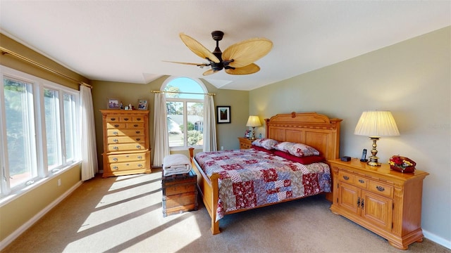 bedroom with ceiling fan, vaulted ceiling, and carpet