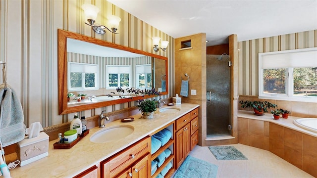 bathroom with independent shower and bath, vanity, and tile patterned flooring