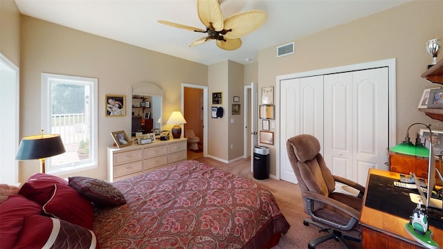 bedroom featuring light carpet, a closet, and ceiling fan