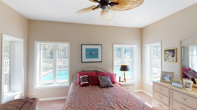 carpeted bedroom featuring multiple windows