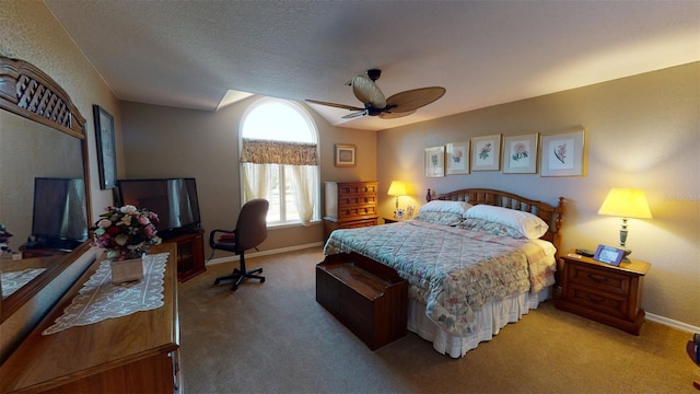 bedroom with ceiling fan, a textured ceiling, and carpet