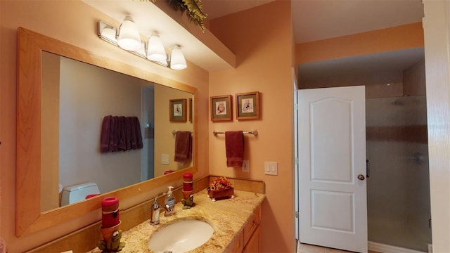 bathroom with vanity, toilet, and walk in shower