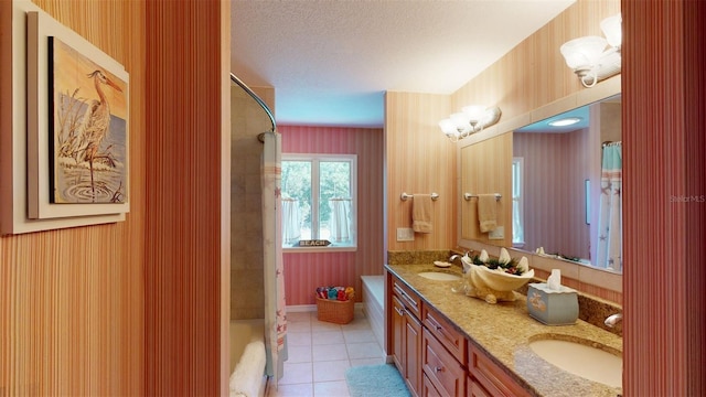 bathroom with tile patterned floors, shower / tub combo, a textured ceiling, and vanity