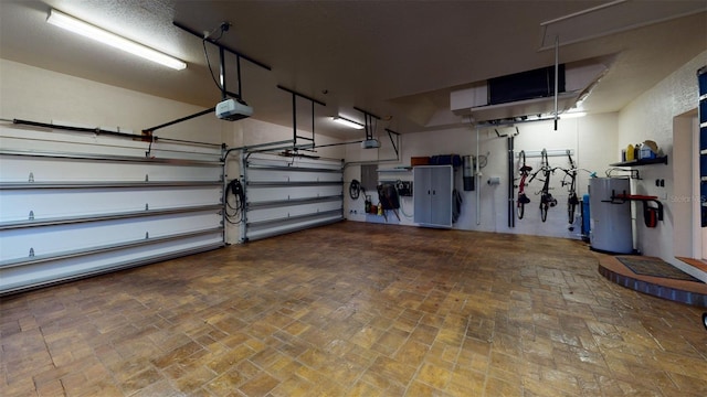 garage featuring water heater and a garage door opener