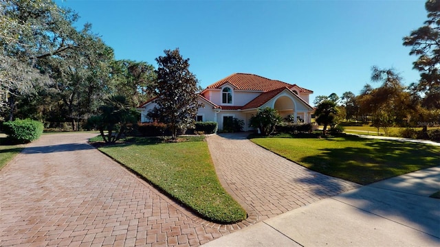 mediterranean / spanish home featuring a front yard