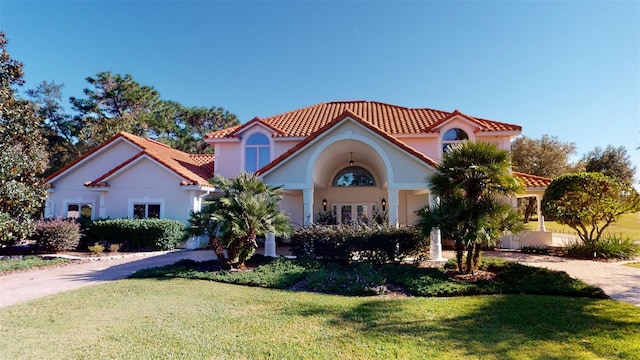 mediterranean / spanish house with a front yard