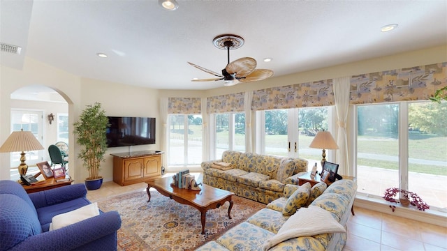 tiled living room with ceiling fan