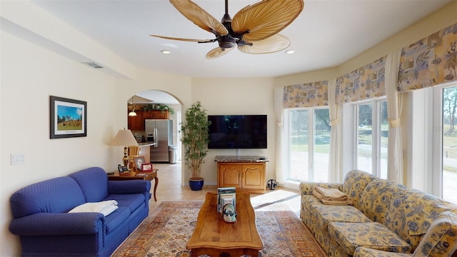 tiled living room with ceiling fan