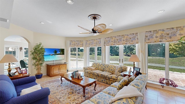 tiled living room featuring plenty of natural light and ceiling fan