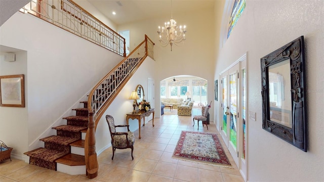 interior space with an inviting chandelier, a high ceiling, and light tile patterned floors