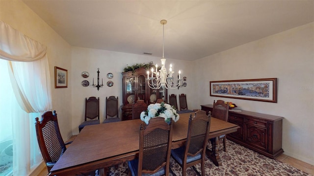 dining space with a notable chandelier