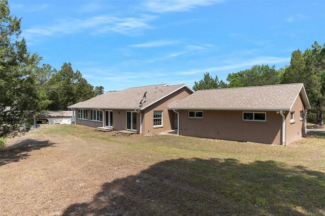 rear view of property with a yard