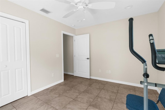 workout area featuring light tile patterned flooring and ceiling fan