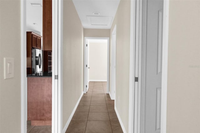 hall featuring dark tile patterned flooring