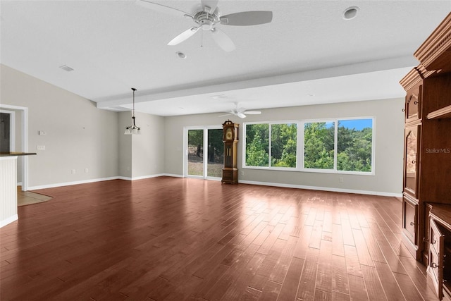 unfurnished living room with a healthy amount of sunlight, dark wood-type flooring, and ceiling fan