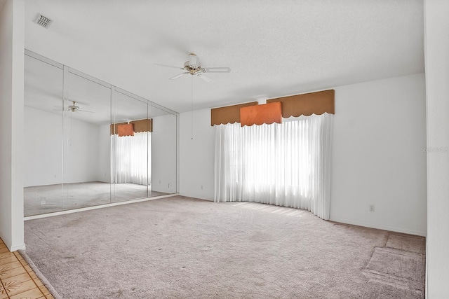 spare room featuring ceiling fan and light colored carpet