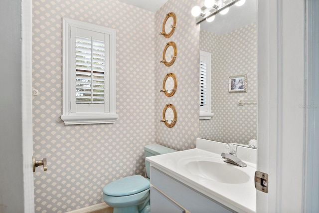 bathroom featuring toilet and vanity