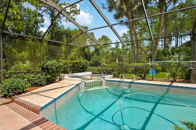 view of swimming pool featuring an in ground hot tub and a lanai