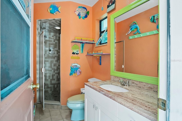 bathroom featuring an enclosed shower, vanity, tile floors, and toilet