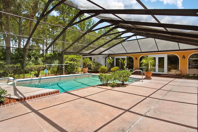 view of swimming pool with a patio area and glass enclosure