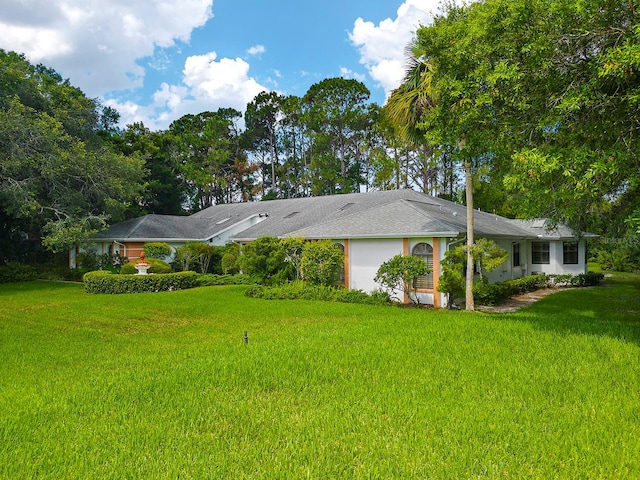 rear view of house featuring a yard