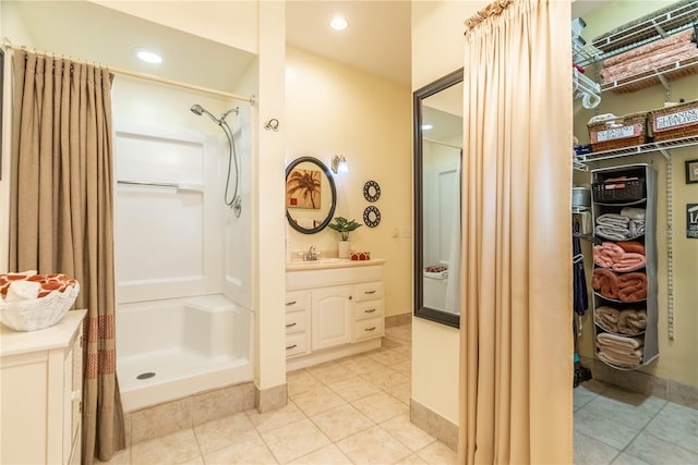 bathroom featuring tile patterned floors, vanity, and walk in shower