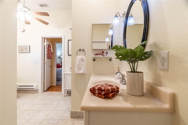 bathroom featuring tile patterned floors, ceiling fan, sink, and baseboard heating