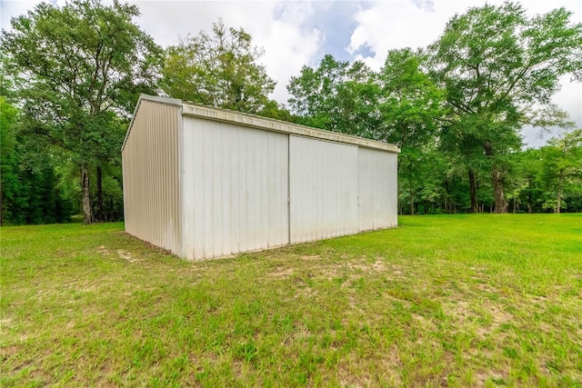 view of outdoor structure featuring a lawn