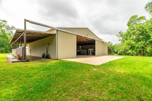 back of property with a lawn and an outdoor structure