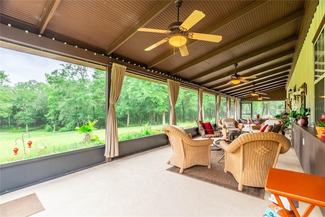 sunroom / solarium featuring lofted ceiling with beams