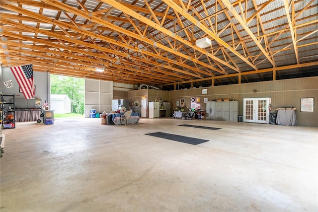 garage featuring french doors and white fridge