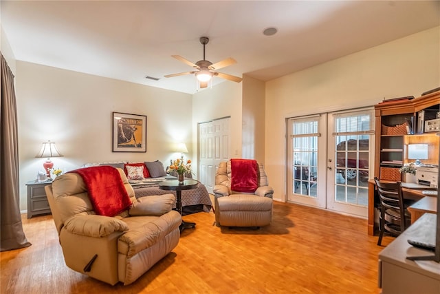 living room featuring french doors, light hardwood / wood-style flooring, and ceiling fan