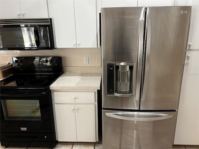 kitchen with tasteful backsplash, white cabinets, and black appliances