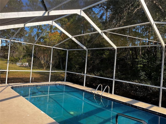 view of pool with glass enclosure