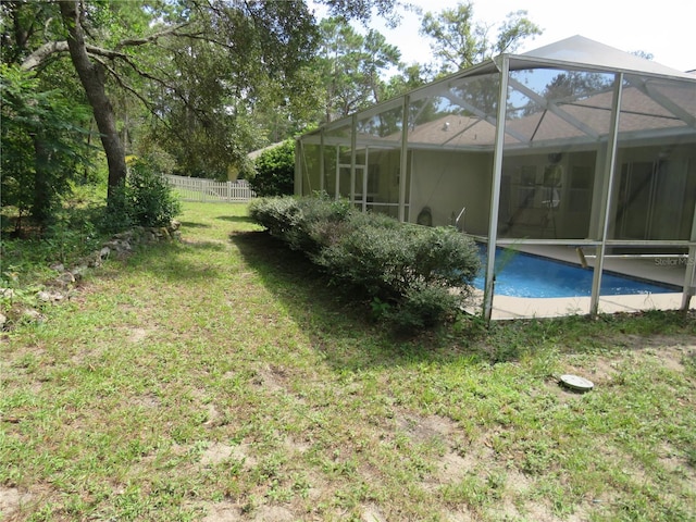 view of yard featuring glass enclosure