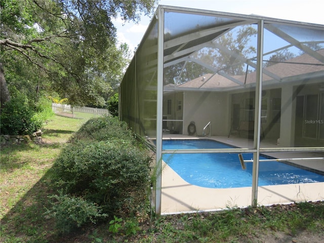 view of pool featuring glass enclosure and a patio area