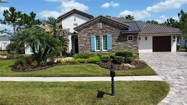 view of front of property with a front yard and a garage