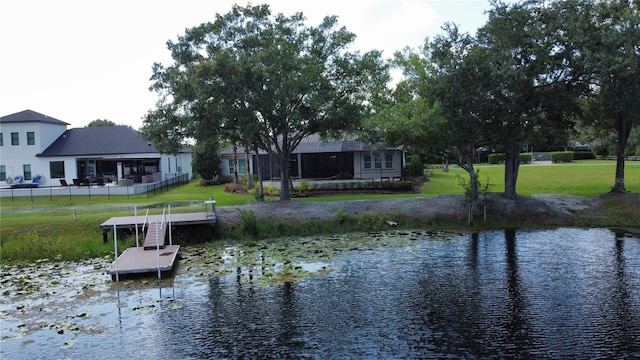 dock area with a yard and a water view