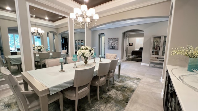 tiled dining area with a raised ceiling, an inviting chandelier, and ornamental molding