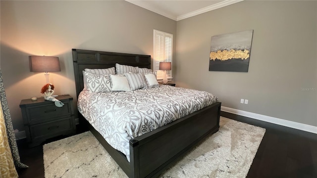 bedroom featuring crown molding and dark hardwood / wood-style flooring