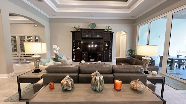 living room featuring a raised ceiling, crown molding, and light tile floors