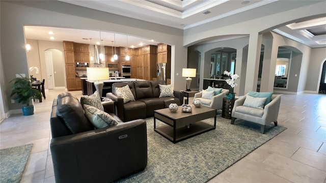 living room featuring light tile flooring, sink, and crown molding