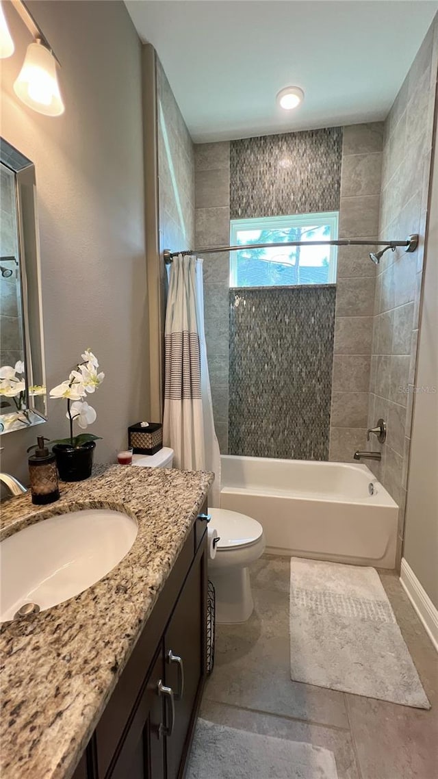 full bathroom with tile floors, vanity with extensive cabinet space, toilet, and shower / bathtub combination with curtain