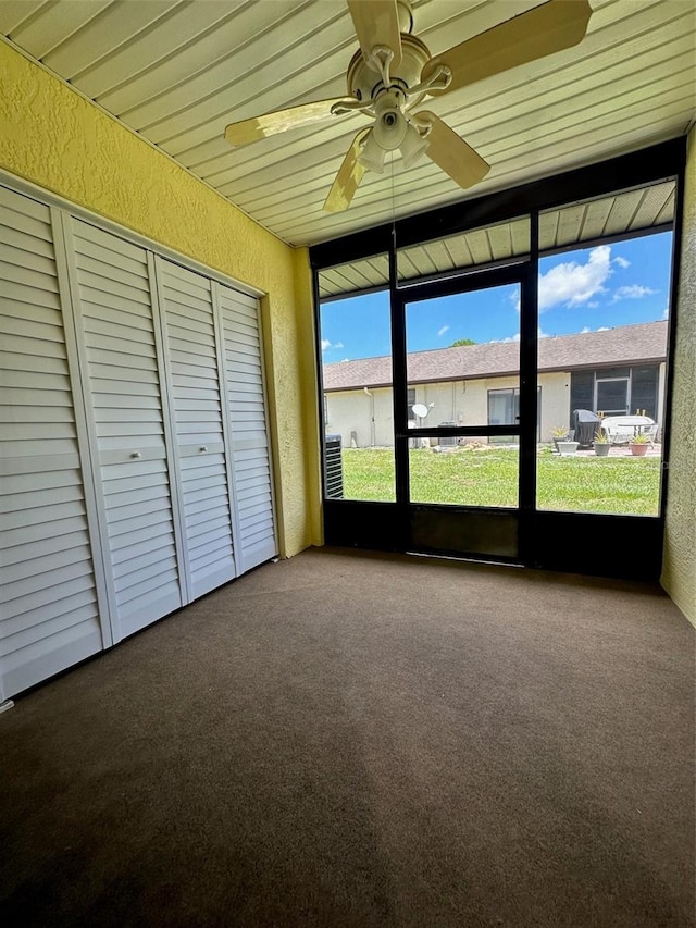 unfurnished sunroom featuring ceiling fan